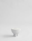White ceramic bowl on a light gray background from 101 Copenhagen at Spacio retail stores in Mumbai & Kolkata.