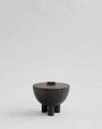 Coffee Colour ceramic bowl with lid on a light gray background from 101 Copenhagen at Spacio retail stores in Mumbai & Kolkata.
