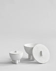 Set of white ceramic bowls on a light gray background from 101 Copenhagen at Spacio retail stores in Mumbai & Kolkata.