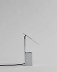 Modern table lamp with a minimalist design on a light gray background