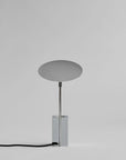 Modern table lamp with a round shade on a gray background