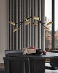 Modern dining room with a black table, gray curtains, and decorative lighting fixture.