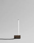 Modern pendant light with a rectangular base on a gray background