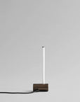 Modern pendant light with a rectangular base on a gray background