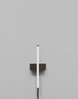 Stick Wall Light Bronze by 101 Copenhagen on a light grey background available at Spacio retail stores in Mumbai & Kolkata.