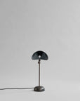 Black table lamp on a gray background