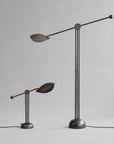Modern floor lamp with adjustable arms on a gray background