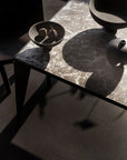 Dark marble table with decorative items from 101 Copenhagen at Spacio retail stores in Mumbai & Kolkata.
