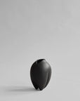 Black vase on a light gray background from 101 Copenhagen at Spacio retail stores in Mumbai & Kolkata.