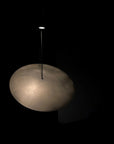 Light fixture with a cloud-like design on a black background