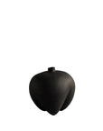 Black vase shaped like a stylized fruit on a white background from 101 Copenhagen at Spacio retail stores in Mumbai & Kolkata.
