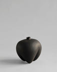 Black ceramic vase on a light gray background from 101 Copenhagen at Spacio retail stores in Mumbai & Kolkata.