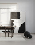 Modern interior with abstract art, a desk, and black vases from 101 Copenhagen at Spacio retail stores in Mumbai & Kolkata.