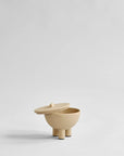 Beige ceramic container with lid on a light gray background from 101 Copenhagen at Spacio retail stores in Mumbai & Kolkata.