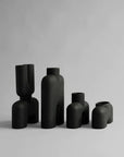 A group of 101Cph Cobra Fat Medio Black 212004 vases on a white background, inspired by the 101 Copenhagen Cobra movement.