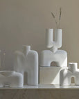 Four 101 Copenhagen 101Cph Cobra Fat Medio Bubble White 201011 vases in white colour sitting on top of a marble table.