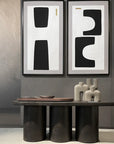 A room with two 101Cph Cobra Tall Mini Dark Grey 211034 vases and two framed pictures. (from the brand 101 Copenhagen)