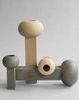 A set of three 101Cph Empire Mini Dark Grey 223036 wooden vases on a dark grey background. (Brand: 101 Copenhagen)