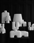 A black and white photo of a group of 101Cph Cobra Uno Mini Bubble White 203021 sculptures by 101 Copenhagen, all in white color.