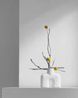 This is a 101Cph Cobra Uno Mini Bubble White 203021 photo of a vase with yellow flowers. The product is by the brand 101 Copenhagen.