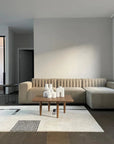 A living room with a beige couch and a coffee table featuring the 101Cph Cobra Uno Mini Bubble White 203021 by 101 Copenhagen.