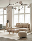 A living room with a 101Cph Guggenheim Mini Coffee 111220 couch and quirky vases. (Brand Name: 101 Copenhagen)