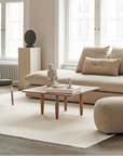 A living room with a 101Cph Guggenheim Mini Coffee 111220 couch and quirky vases. (Brand Name: 101 Copenhagen)