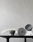 Three gray ceramic bowls on a black table against a light gray wall from 101 Copenhagen at Spacio retail stores in Mumbai & Kolkata.