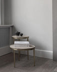 Two round side tables with books and small decorative items against a neutral wall from 101 Copenhagen at Spacio retail stores in Mumbai & Kolkata.