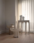 Modern interior with a table and chairs in a room with light-colored curtains.