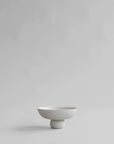 White ceramic bowl on a light gray background from 101 Copenhagen at Spacio retail stores in Mumbai & Kolkata.