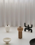 Set of modern ceramic decor pieces on a white surface with a white curtain background from 101 Copenhagen at Spacio retail stores in Mumbai & Kolkata.