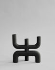 Black abstract candle holder on a light gray background from 101 Copenhagen at Spacio retail stores in Mumbai & Kolkata.