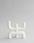 White abstract candle holder on a light gray background from 101 Copenhagen at Spacio retail stores in Mumbai & Kolkata.