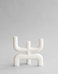White abstract candle stand on a light gray background from 101 Copenhagen at Spacio retail stores in Mumbai & Kolkata.