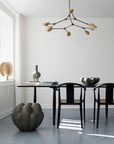 A dining room with a 101Cph Duck Fat Dark Grey 111281 table and chairs in dark grey colour by 101 Copenhagen.
