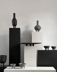 A group of 101Cph Duck Fat Dark Grey 111281 vases by 101 Copenhagen on a table.