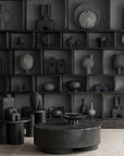 A room with many 101Cph Duck Fat Dark Grey 111281 vases and a coffee table in a dark grey color.