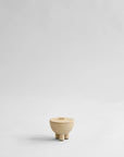 Small beige ceramic bowl with a lid on a light gray background from 101 Copenhagen at Spacio retail stores in Mumbai & Kolkata.