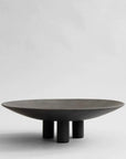 A black 101Cph Duck Plate Big Coffee 214049 by 101 Copenhagen on a white background with a Scandinavian home aesthetic.