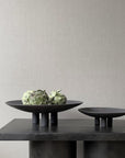 Two black 101Cph Duck Plate Mini Coffee 214048 bowls on a table next to each other in a Scandinavian home by 101 Copenhagen.