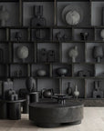 A room with many black 101Cph Duck Plate Mini Coffee 214048 vases and a coffee table in a Scandinavian home.