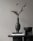 A 101Cph Duck Slim Coffee 111280 ceramic vase sits on top of a table.