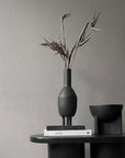 A 101Cph Duck Slim Coffee 111280 ceramic vase sits on top of a table.