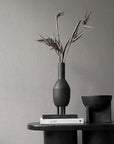 A 101Cph Duck Slim Coffee 111280 ceramic vase sits on top of a table.