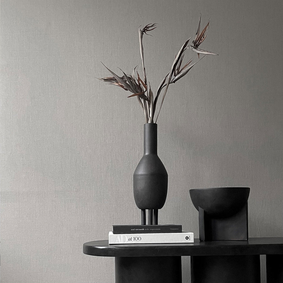 A 101Cph Duck Slim Coffee 111280 ceramic vase sits on top of a table.