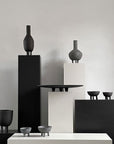 A collection of 101Cph Duck Slim Coffee 111280 ceramic vases in black and white, displayed on a table.