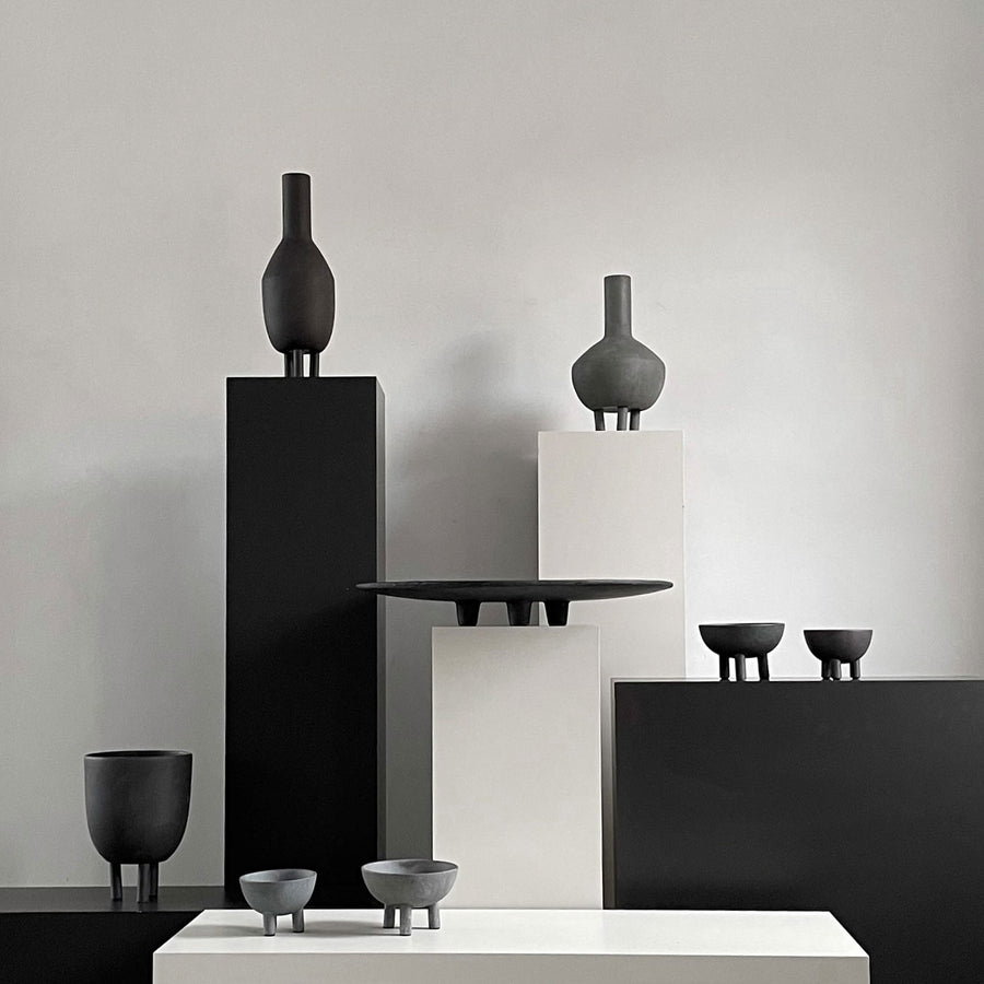 A collection of 101Cph Duck Slim Coffee 111280 ceramic vases in black and white, displayed on a table.
