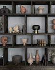 A shelf filled with a wide variety of quirky vases, including the 101Cph Duck Vase Fat Taupe 213045 by 101 Copenhagen, showcasing the unique and creative pieces inspired by the Cobra Arts Movement.