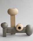 A set of three 101Cph Empire Mini Sand 223037 vases on a grey background, by 101 Copenhagen.
